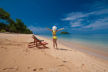 Fototapeta na wymiar Thailand. Woman sea, bikini, hat, tan, sunbed. Libong