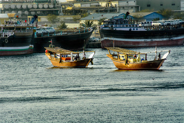 Obraz premium Fisherman sailing in fishing boat on water