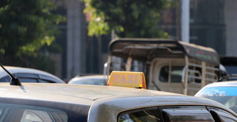 Fototapeta premium Taxi light sign or cab sign in yellow color on the car roof.