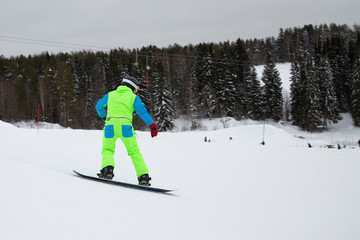 snowboarder jumping on mountain slope