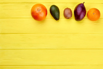 Fresh tropical fruits and copy space. Assortment of colorful exotic fruits and text space.