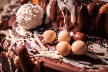 Chocolate, chocolate cookies and candies like a decoration on homemade cake