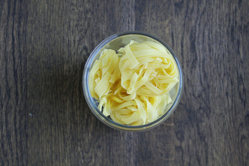 Pasta in a can on a wooden table