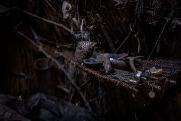 Shelf filled with hunting gatherings, small tools and crafted trinkets