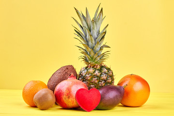 Still life of fresh tropical fruits. Composition from delicious tropical fruits on colorful background.