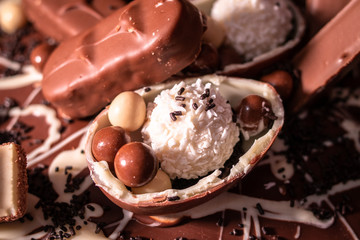 Chocolate, chocolate cookies and candies like a decoration on homemade cake