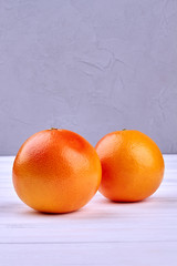 Fresh healthy grapefruits and copy space. Juicy organic grapefruits on wooden background. Grapefruit for weight loss.
