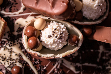 Chocolate, chocolate cookies and candies like a decoration on homemade cake