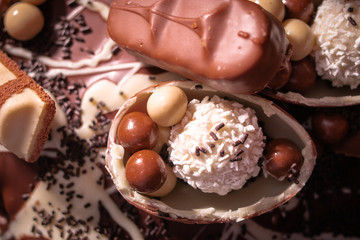 Chocolate, chocolate cookies and candies like a decoration on homemade cake