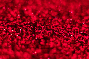 Red glitter texture. Festive sparkling sequins background closeup. Wpaper for Valentine, New Year or Christmas Holidays.