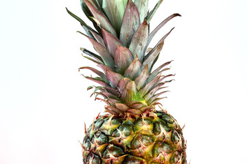 Hawaiian pineapple on pink background. Healthy exotic ananas on color background, cropped image.