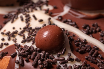 Chocolate, chocolate cookies and candies like a decoration on homemade cake
