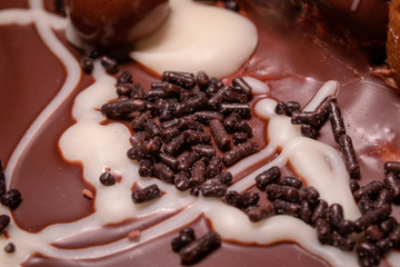 Chocolate, chocolate cookies and candies like a decoration on homemade cake