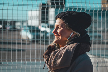 Happy women listening music using wireless headphones in sunny day