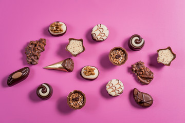Collection of chocolate sweets on colorful background