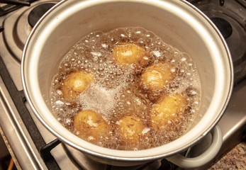 Potatoes are cooked in a pan in the kitchen