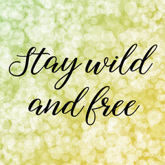 Stay wild and free. Calligraphy saying. Bokeh background. Quote for Social media post