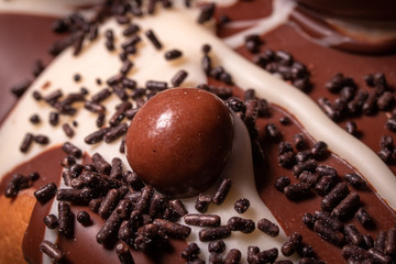 Chocolate, chocolate cookies and candies like a decoration on homemade cake