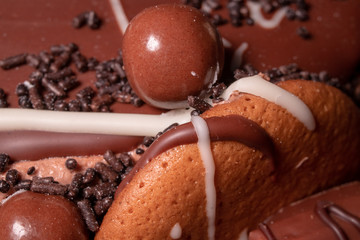 Chocolate, chocolate cookies and candies like a decoration on homemade cake