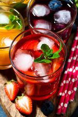 fresh fruit and berry beverages with ice in assortment