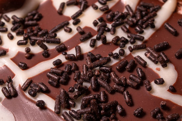 Chocolate, chocolate cookies and candies like a decoration on homemade cake