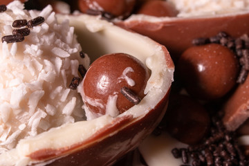 Chocolate, chocolate cookies and candies like a decoration on homemade cake