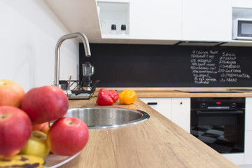 Modern white kitchen in scandinavian style. kitchen sink white with fruit induction plate