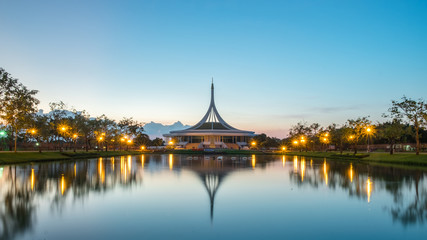 Monument in public park of thailand. Twilight at Suanluang RAMA IX Public Park reflection on water and botanical garden,