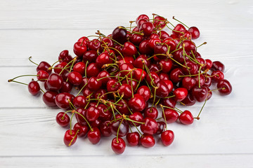 Cherries on white background. Pile of red sweet berries. Summer fruity background. Taste of summer.