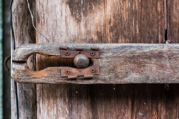 Rusty lock of old gates.Vintage door with metal handle. © chollacholla
