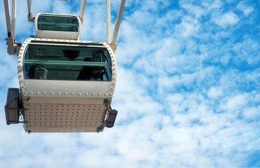Ferris wheel. People look at the panorama of the Spanish city of Malaga from the Ferris Cabin.