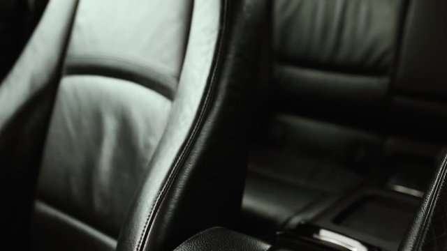 black leather upholstery in the interior of a luxury business class car.