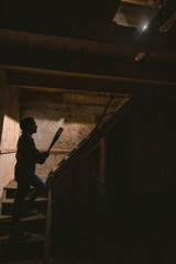 man in leather jacket and baseball bat