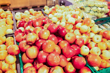 Naklejka na ściany i meble Large selection of red green and yellow apples in baskets in supremacret