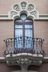 traditional spanish window with balony and stucco decoration © Janine