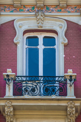 colorful red window in southern spain with decoration and stucco