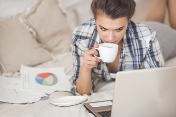 Young attractive woman working at laptop