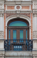Fototapeta na wymiar traditional window in Spain with extravagant stucco decoration