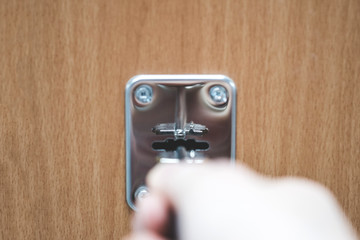 key in keyhole. hand inserts the key into the keyhole