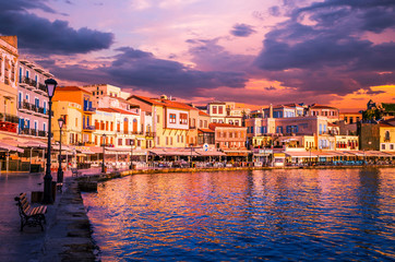 Fototapeta na wymiar CHANIA, CRETE ISLAND, GREECE - JUNE 26, 2016: Stunning sunset view of the old venetian port of Chania on Crete island, Greece.