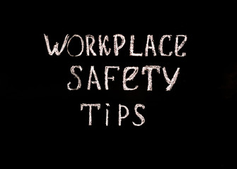 Fototapeta na wymiar Black background with the inscription workplace safety tips . Safety concept.