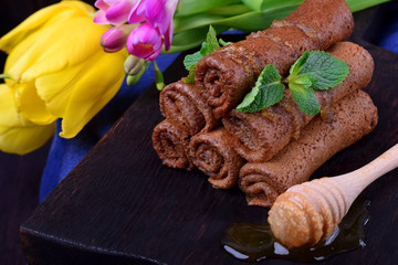 Chocolate rolled crepes topped with honey and mint