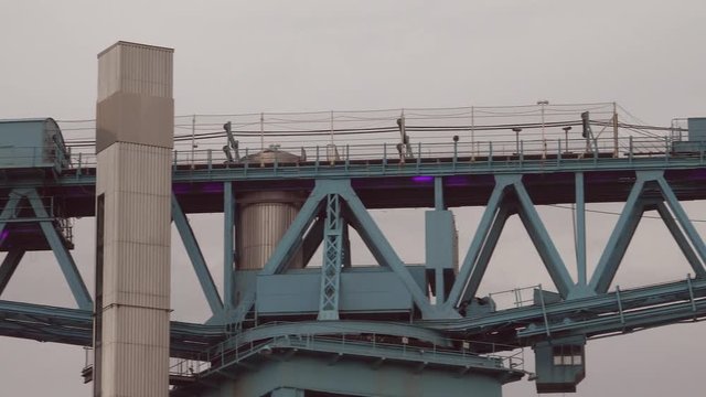 Panning to the right along the top of the Titan Crane, a 150 foot high cantilever structure, on the Clyde riverside at Clydebank. 