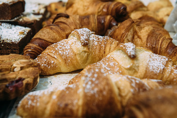 Powder Sugar Covered Croissant in a Coffee Shop - 251207224