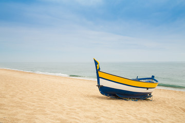 Wooden fishing boat on a sandy beach