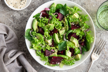 healthy vegan avocado and beet salad in white  bowl