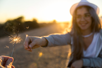 pretty young girl with hat on sunset