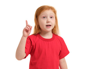 Portrait of cute redhead emotional little girl with finger up isolated on a white