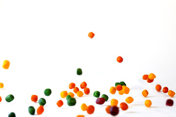  Falling round different color candies.