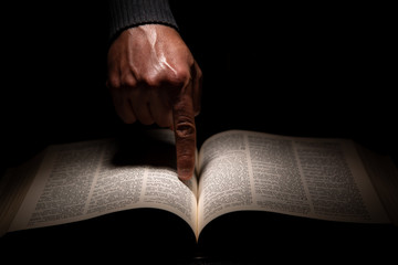 African American Man Pointing to the Bible, the Word of God